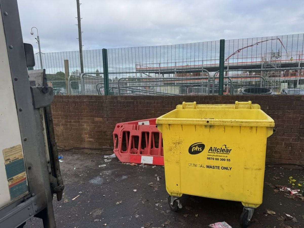 Tidy commercial bin store after overflowing waste was cleared away